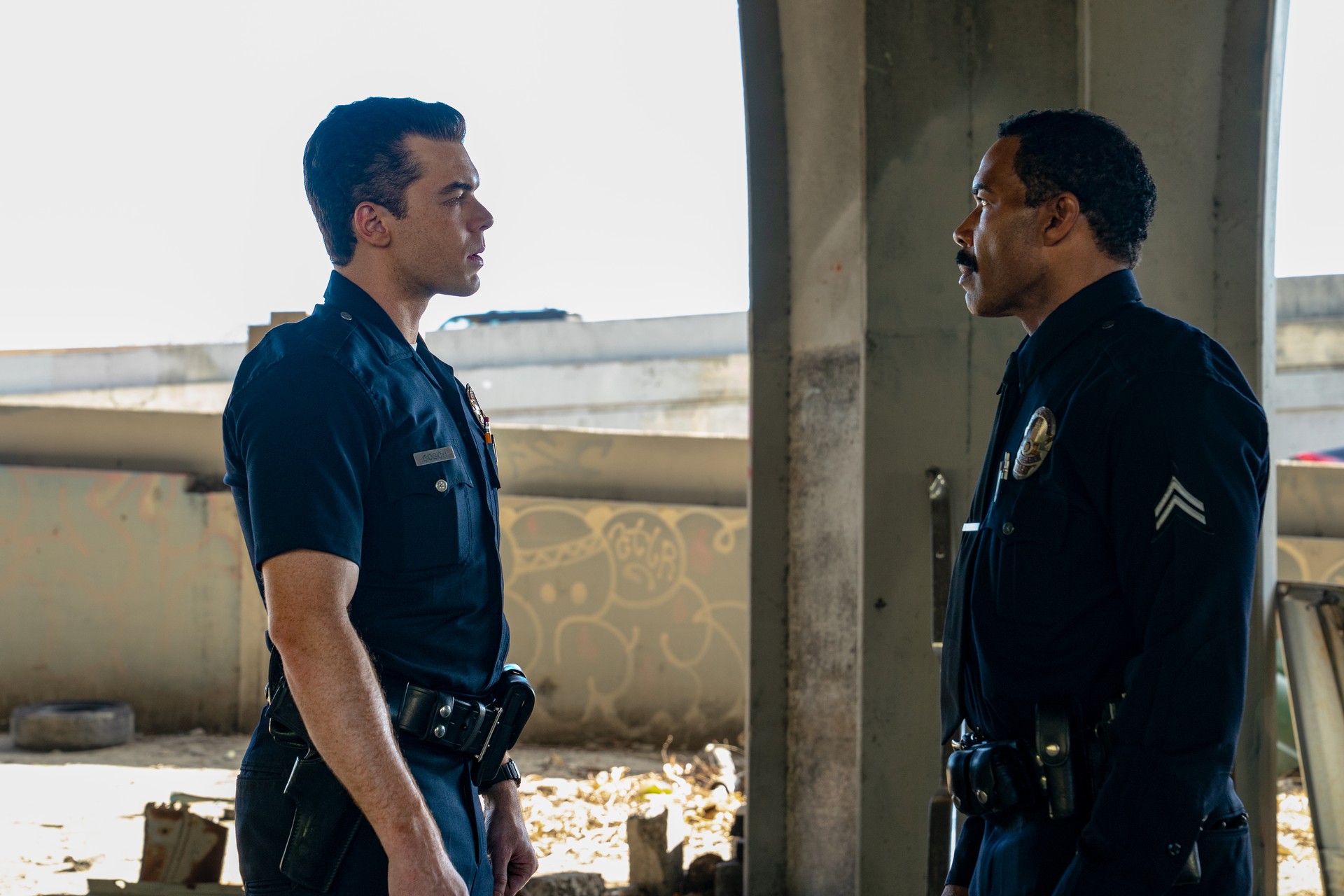 Cameron Monaghan as rookie Harry Bosch faces Omari Hardwick as training officer Eli Bridges in Bosch: Start of Watch.