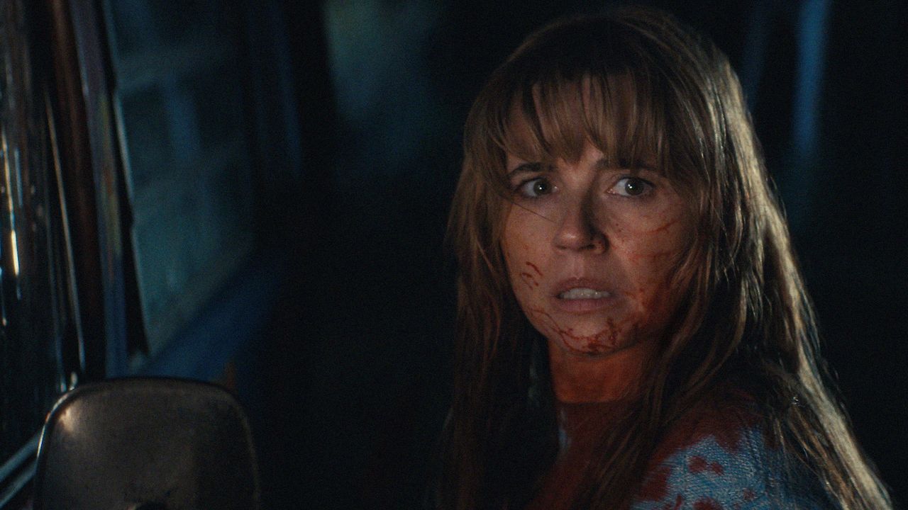 Linda Cardellini as Pamela Voorhees, with blood on her face in a scene from Crystal Lake season one.