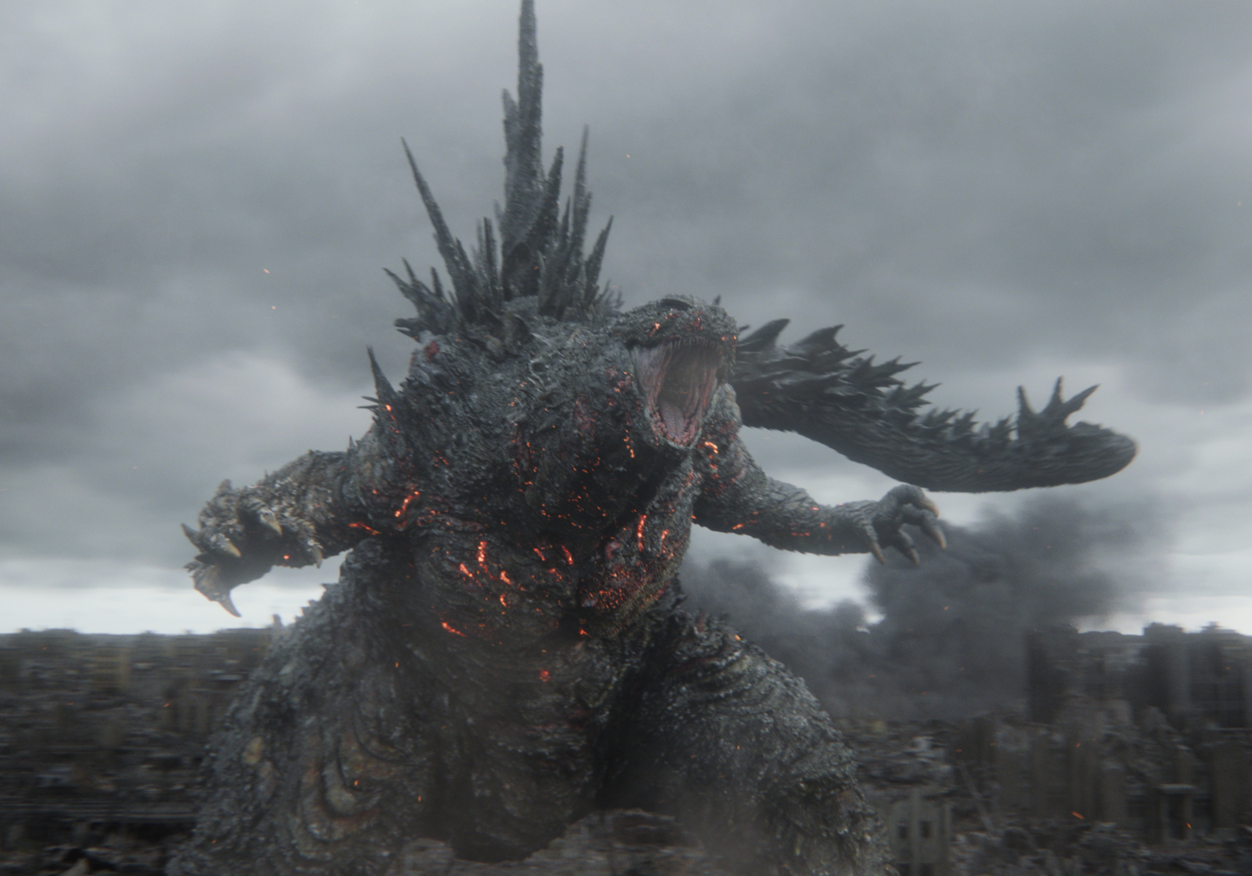 Godzilla roaring above a ruined city in an official Godzilla Minus Zero production still.