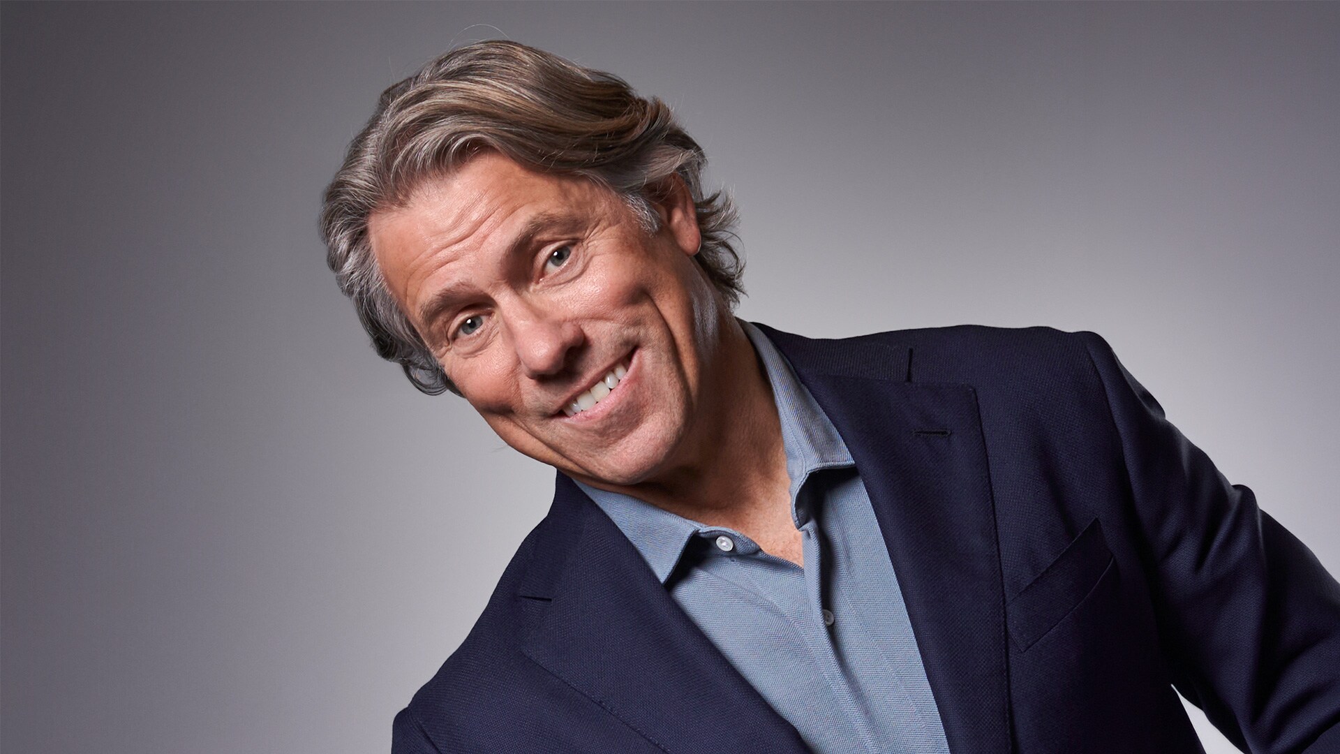 John Bishop smiles in the official publicity portrait supplied with Sky’s Coliseum comedy-series announcement.