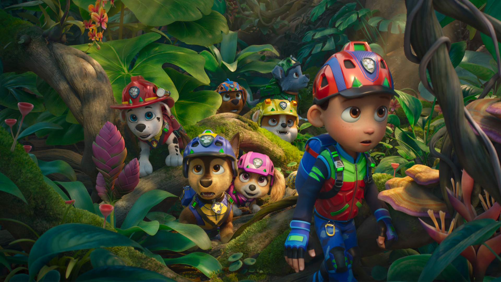 Ryder and the rescue pups explore a lush dinosaur island in PAW Patrol: The Dino Movie.