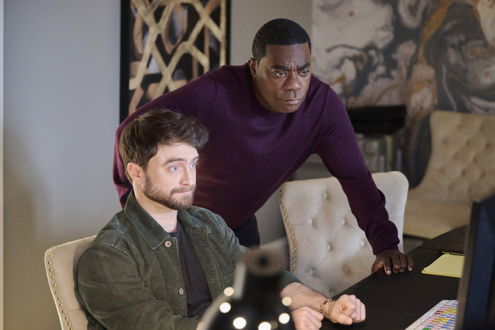 Daniel Radcliffe and Tracy Morgan lean towards a computer in The Fall and Rise of Reggie Dinkins.